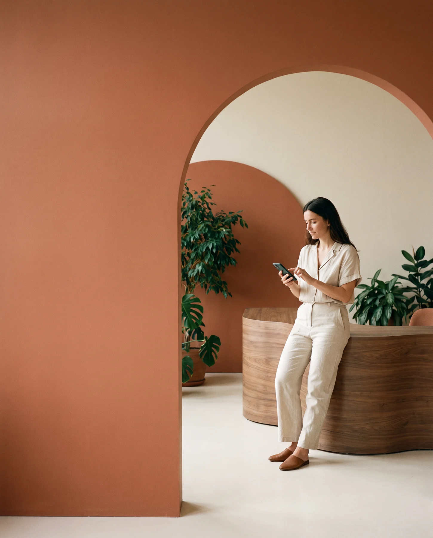 Designer using a phone in a botanical studio